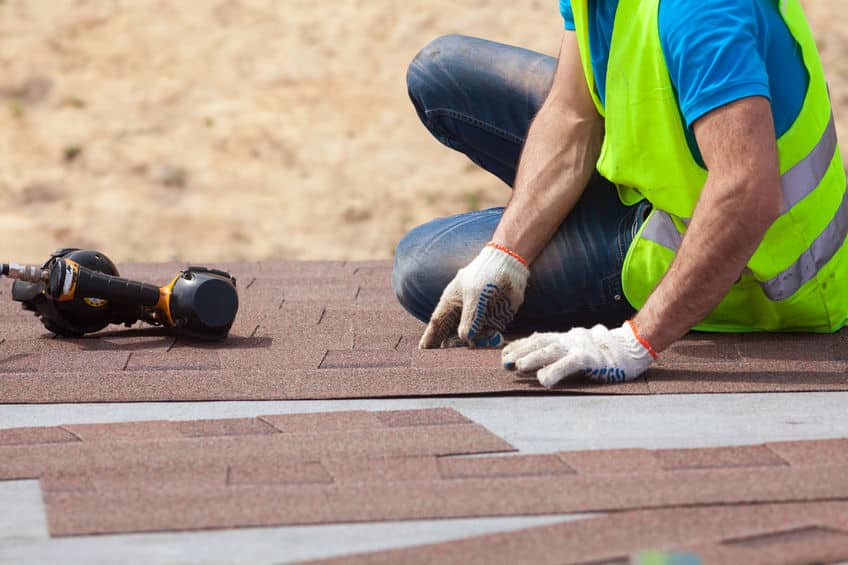 Picture of roofing contractor working roof.