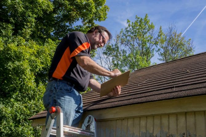 Picture of contractor figuring out roofing quote.