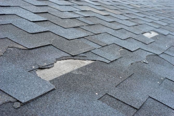 Picture of storm damage to asphalt shingles.