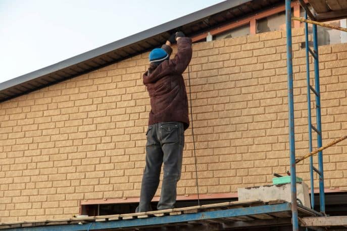 Picture of contractor installing siding.