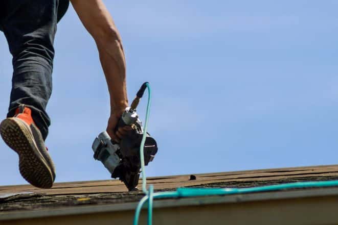 Picture of exterior contractor replacing a roof.