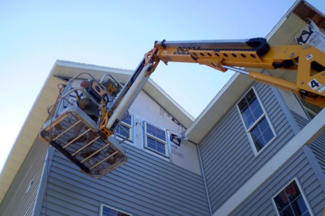 Picture of contractor working on siding.